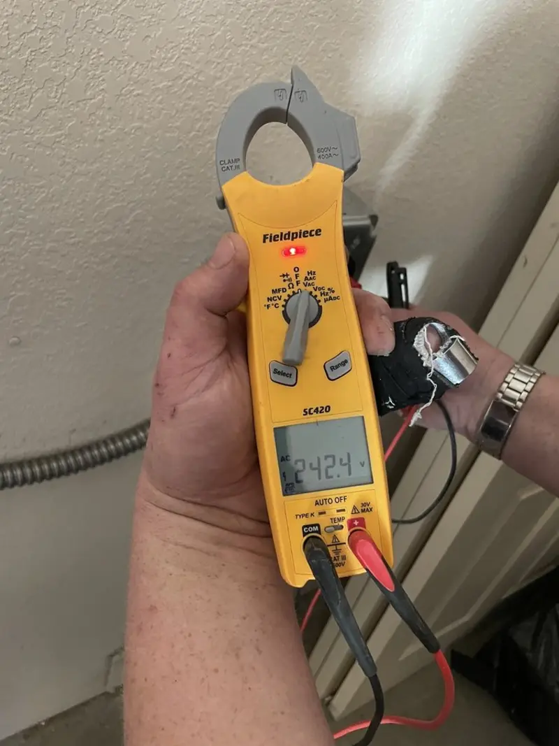 Voltage testing with clamp meter during Recessed Lighting Installation in Whitney